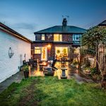 Rear garden terrace with seating area and outdoor lighting for evening entertaining at 46 Hodge Lane Hartford