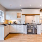 Shaker style fitted kitchen with range cooker and tiled splashback at 46 Hodge Lane Hartford