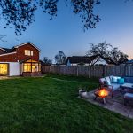 Twilight view of Orchard House garden and patio seating area in Lach Dennis Cheshire