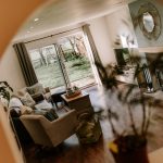 Living room with sliding doors opening to the garden at Orchard House Lach Dennis Cheshire