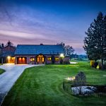 Front elevation with pond and landscaped gardens at twilight in Acton Bridge