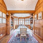 Arts and Crafts style dining room with original wood panelling and decorative ceiling in Bostock Cheshire