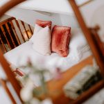 Bedroom detail reflected in mirror with soft furnishings in a character home in Bostock