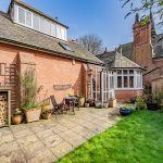 Patio and garden seating area within a character property courtyard at Bostock Hall estate