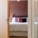 View through to bedroom with layered styling and soft furnishings in a detached Davenham property