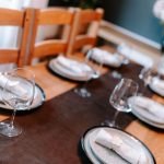 Dining table detail with glassware and place settings, highlighting the space’s suitability for hosting