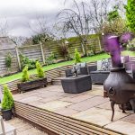 Outdoor seating area set within landscaped terrace, offering space for entertaining and relaxation