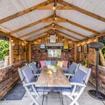 Covered outdoor entertaining area at 215 Hartford Road, Davenham with seating, lighting and sheltered garden dining space.