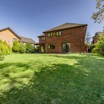 Rear elevation of The Beeches, Royal Gardens, Davenham showing the detached home and mature garden setting