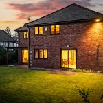 Twilight rear elevation at The Beeches, Royal Gardens, Davenham with illuminated interiors and garden outlook.