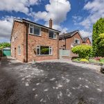 Front approach to this detached family home in Davenham, featuring extensive driveway parking and detached garage.