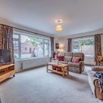 Principal living room within this detached family home in Davenham, featuring generous proportions and windows positioned to two elevations