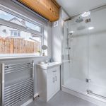 Updated shower room within this four-bedroom detached property in Davenham, finished with a modern walk-in shower and contemporary fittings.
