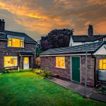 Twilight rear elevation of this detached family home in Davenham, showcasing the garden and evening atmosphere across the plot.