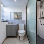 Contemporary shower room at The Barns, Bostock Hall Estate, featuring walk-in shower, modern vanity unit and sleek tiled finishes