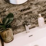 Detail image of the contemporary en suite at The Barns, Bostock Hall Estate, featuring modern basin and textured wall finish