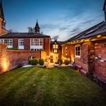Private rear patio seating area at The Barns, Bostock Hall Estate, with contemporary outdoor entertaining space and feature lighting