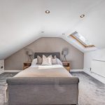 Vaulted bedroom at The Barns, Bostock Hall Estate, featuring soft neutral interiors and contemporary styling