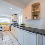 Galley-style kitchen with fitted cabinetry and natural light