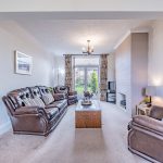 Through lounge with feature fireplace and access to superb rear garden