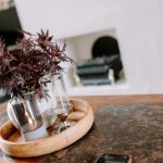 Living room styling detail with fireplace and coffee table arrangement