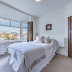 Principal bedroom with large bay window and fitted furnishings