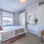 Second double bedroom with fitted storage and soft neutral interior styling