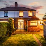 Rear elevation and garden of Eaton Lane home captured at dusk
