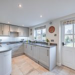 Bright kitchen with rear garden access at Pear Tree Farm in Davenham.