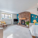 Cosy lounge with wood burning stove and feature brick chimney in Davenham