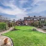 Closer rear elevation view showing patio and garden at Pear Tree Farm in Davenham.