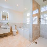 Ensuite bathroom with bath, shower screen and modern suite