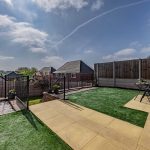 Garden with open views, patio seating and raised levels