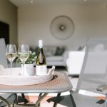 Garden patio seating area with access to home through large glazed doors