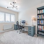 Home office or study with desk and window providing natural light