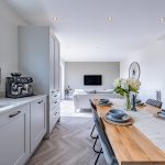 Living area with sofas and bi-fold doors opening to garden