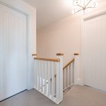First floor landing with staircase and white balustrade
