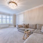 Lounge with bay window and large sofa in light filled space