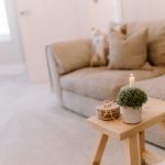 Lounge detail with side table, candle styling and soft furnishings