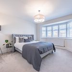 Principal bedroom with bay window and fitted shutters