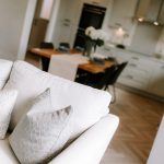 Open plan living and dining space with sofa leading through to kitchen in detached Hartford home