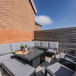 Outdoor seating area with corner sofa and patio space for entertaining