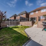 Rear garden view with lawn, patio and enclosed fencing