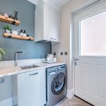 Utility room with sink, storage and rear access door