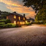 Front elevation of premium detached Sandiway home at twilight with extensive private driveway