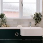 Bathroom vanity detail at 11 Sandington Drive, Cuddington, with modern basin, decorative planting and tiled splashback.