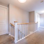 First floor landing at 39 Albemarle Avenue, Hartford, with white balustrade, neutral carpet and access to the upstairs bedrooms.