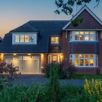 Twilight front exterior of 39 Albemarle Avenue, Hartford, with illuminated windows, double garage, landscaped frontage and driveway.