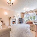Spacious living room with feature fireplace and large bay window in a detached family home in Kingsmead, Northwich.