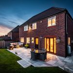 Rear elevation of a detached family home in Kingsmead, Northwich with a landscaped garden, paved entertaining terrace and outdoor seating area